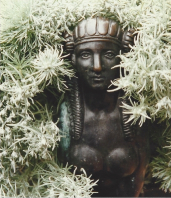A bust is framed by silvery foliage at Sissinghurst