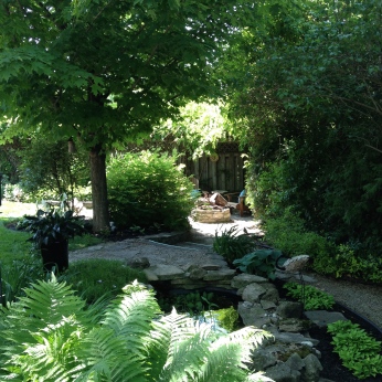 A pathway leads along the width of a small garden.