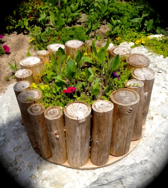 Logs are used to make a large plant container